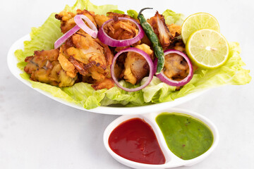 Onion Pakoda Also Known As Kanda Bhajji, Pyaj Ke Pakode, Pakoda, Pyaaj Pakore, Pakora, Pyaaz Bajji Is Enjoyed In Rainy Season Across North And South India. Served With Green Chutney And Ketchup Sauce
