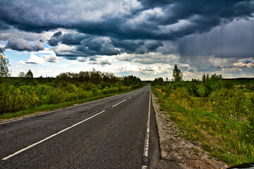 Fototapeta na wymiar Rain clouds over the highway. grainy photo. 