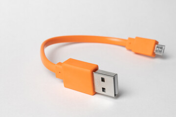 Orange USB micro-usb cabel isolated on grey background