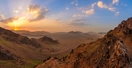 sunset behind mountains  