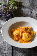 Homemade ravioli stuffed with borage and potatoes dressed with vegetarian ragout