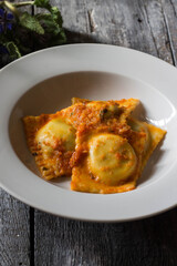 Homemade ravioli stuffed with borage and potatoes dressed with vegetarian ragout