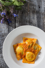 Homemade ravioli stuffed with borage and potatoes dressed with vegetarian ragout