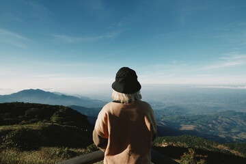 young Japanese cute teen girl brunette women tourist adult woman asian mature looking the sky outdoors on a hike mountains camping taking a photo
at Doi Inthanon National Park, Chiang Mai, Thailand.