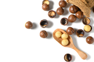 Obraz na płótnie Canvas Peeled macadamia nuts in wood spoonl isolated on white background,