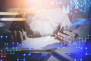 Front view of businesswoman working with smartphone and laptop at office. Digital security and data storage concept in business process. Information icons flying in the air.