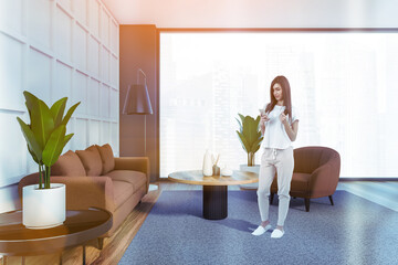 Young attractive woman wearing white t-shirt in living room