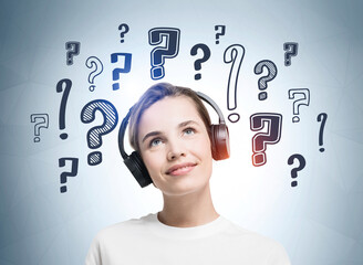 Smiling businesswoman with headphones is listening educational podcast