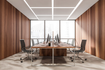 Business room interior with armchairs and computers, city view