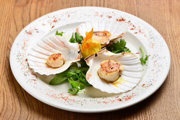 Grilled scallops on the plate with salad