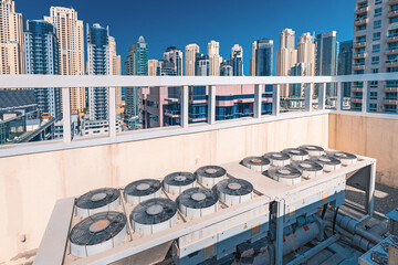 Worn and old ventilation and air conditioning system on the roof of a skyscraper building. Climate...