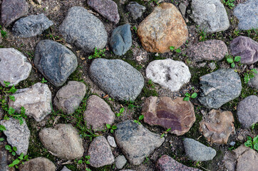 Old road made of different stones, texture
