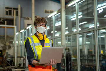 Industrial factory employee wearing protection face mask are working in metal manufacturing industry.