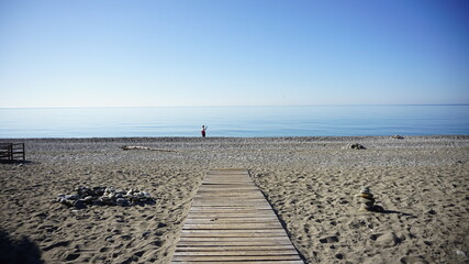 person walking on the beach