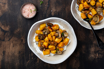 homemade pumpkin gnocchi with mushroom sauce and ricotta