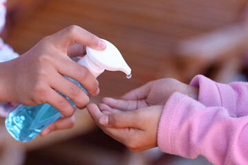 Hand cleaning with alcohol gel, Pressing the alcohol bottle.