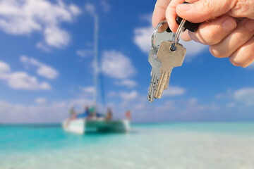 concept success. A key is on backkground of yacht in blue ocean.