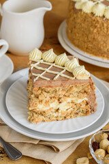 A piece of homemade Kiev or dacquoise cake with hazelnuts and buttercream.  Selective focus. 
