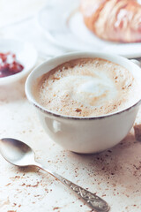 Coffee with milk on bright stone background. Close up.	