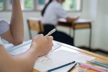 Hands Student testing in exam on exercise taking at high school or university in test room. Writing...