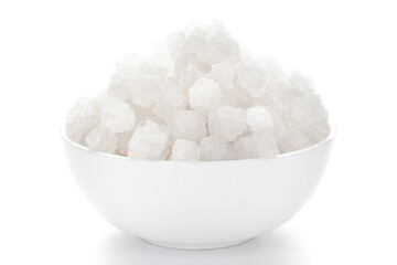 Close-up of coarse sea Salt (sodium chloride) edible on the white ceramic bowl. 