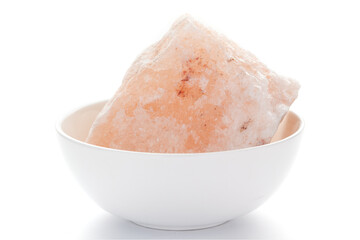  Close-up of coarse Himalayan Pink Salt (sodium chloride) edible on the white ceramic bowl. 