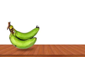 Green bananas on wooden table