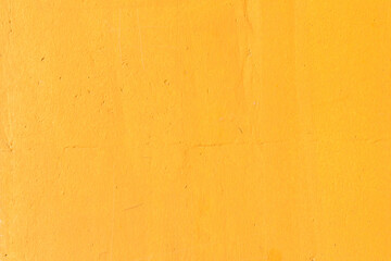 The wall of the house painted with yellow paint
