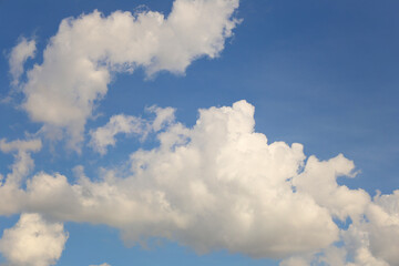 Blue sky with white clouds in the daytime background.