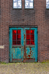 Fototapeta na wymiar Old rusty double door in industrial building