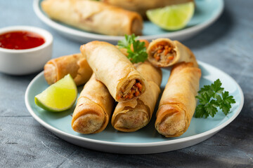 Fried spring rolls with sweet chili sauce and lime on plate - obrazy, fototapety, plakaty