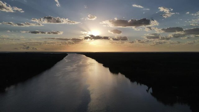 Panoramic aerial high shot of river at sunset beautiful sky in South America