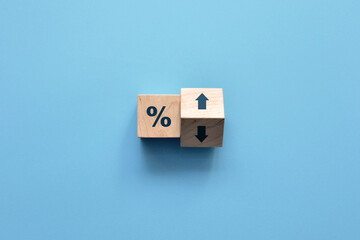 Wooden cubes with percentages and up and down arrows. Increase or decrease in interest on profits,...
