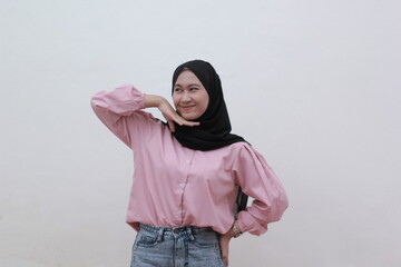 Portrait of confident young Asian woman has an cute face and puts her hands under her chin on white background. Beautiful asian woman with casual dress. Beautiful muslim women. 