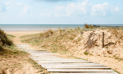 Panoramic view of the sea and wooden pathway leading to the beach