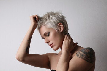 Fototapeta premium Close-up portrait of fashion blond young woman with short hair. Studio shot.
