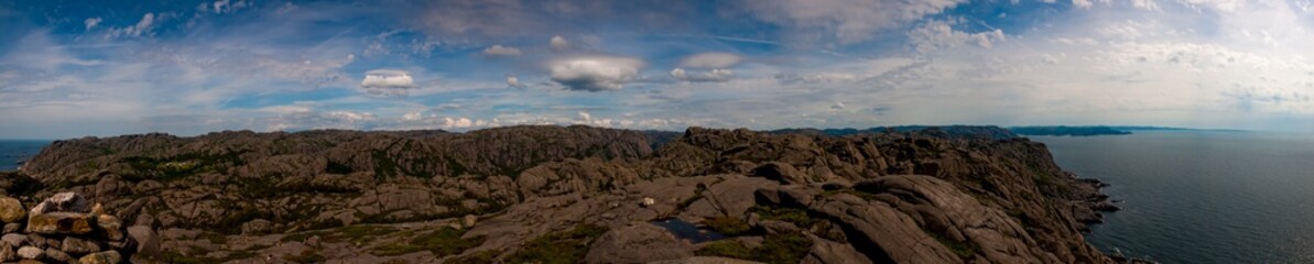 View from the Preikestolen, towards the Lysefjord in Norway. Pulpit Rock - Popular mountainous hike to a famed 604 meter cliff with a flat top, offering panoramic views. - obrazy, fototapety, plakaty