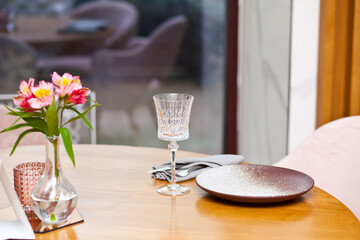Restaurant dinner table place setting with empty glass and plate