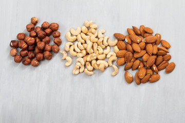 group of nuts on grey concrete background, healthy food concept
