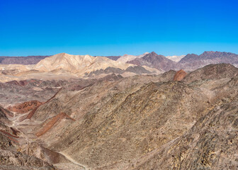 Fototapeta na wymiar The trail goes through a rocky desert canyon.