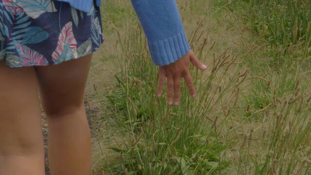 Sexy Girl's Hand Feeling And Touching Tall Grass While Walking At Track In Crescent Head, NSW, Australia. - close up