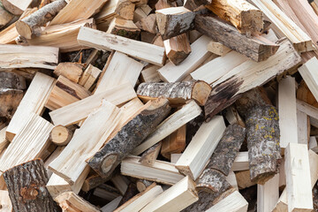 Preparing for the firewood heating season. Chopped firewood of different trees