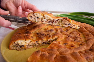 Close up of a slice of calzone - Traditional stuffed pizza of Puglia