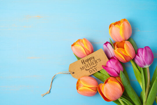 Happy Mother's day concept with beautiful tulip flowers  on wooden background with copy space