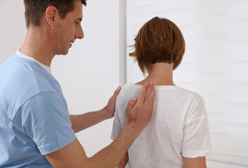 Obraz premium Mature Woman suffering from back pain having chiropractic back adjustment. Osteopathy, Alternative medicine, pain relief concept.