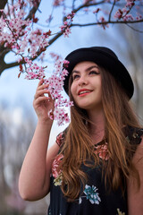 Young woman with cherry trees in bloom
