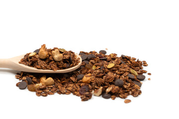 Chocolate granola cereal with nuts in a wooden spoon.