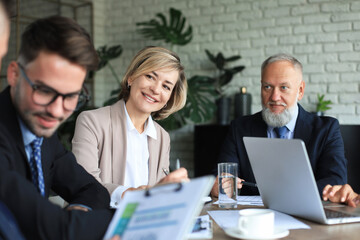 Fototapeta premium Group of business partners discussing ideas and planning work in office.