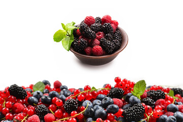 Blackberry, raspberry, blueberry,  red currant and mint background. Isolated on white. Copy space.
