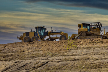 Under construction of a new asphalt road. The excavators, graders working on the new road construction